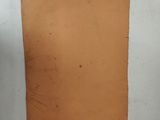 a piece of brown paper sitting on top of a white table