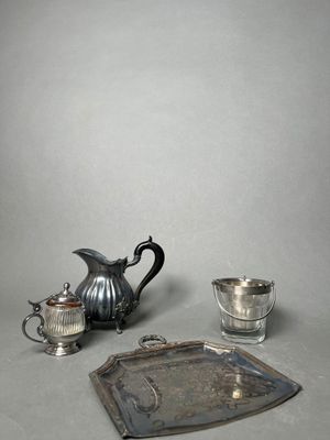 a silver tea pot and a silver tray on a table