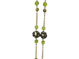 green and black beaded necklace on a white background