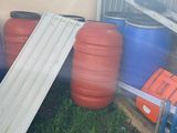 a pile of barrels and barrels sitting in the grass