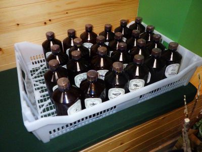 many bottles of beer in a basket on the counter