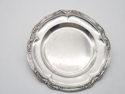a silver plate on a table with a white background