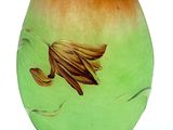a green and orange vase with a gold fish on it