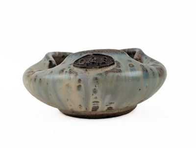 a small bowl that is sitting on a white surface