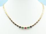 a gold necklace with multi colored stones on a mannequin