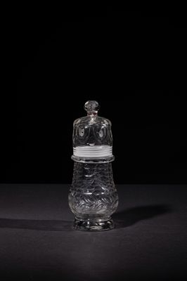 a small glass jar with a lid on a table