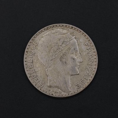 an old silver coin with a woman ' s head and a crown on it