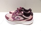 purple and pink skecher shoes on a white surface