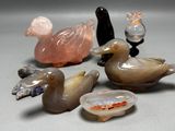 a lot of glass ducks that are sitting on a table
