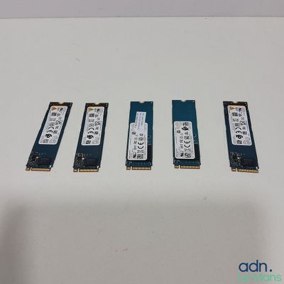 four memory modules are sitting on a white surface next to each other