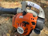 a leaf blower sitting on the ground in the grass