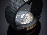 a close up of a watch on a black surface
