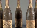 six bottles of wine are lined up in a row