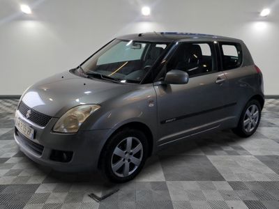 a picture of a silver suzuki minivan in a room