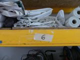 many rolls of fabric on a shelf in a box