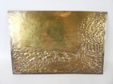 brass plate with a picture of a man in a boat on the water