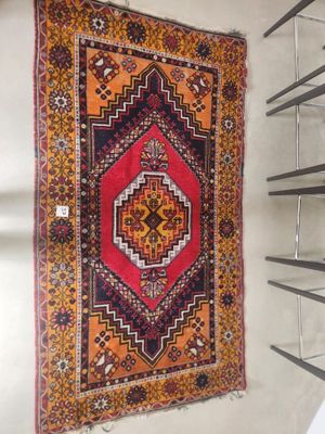 a rug hanging on a wall in a room