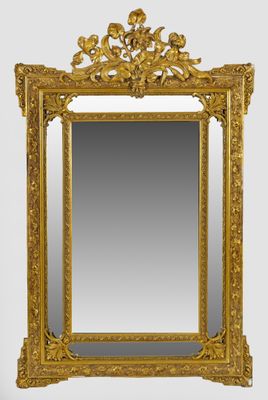 an ornate gold framed mirror on a white wall