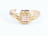 a close up of a gold ring with a pink stone in the center