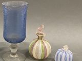 three glass vases sitting next to each other on a table