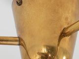 a gold vase with a handle on a stand