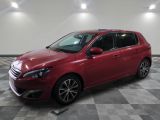 a red car parked in a garage with a checkered floor