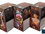 three boxes of one piece action figures on a white background