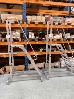 a man that is standing in front of a rack with boxes