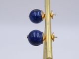 pair of lapis and gold earrings with blue beads on a gold plated stand