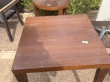 a small table and two chairs in the yard