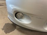 a close up of a car ' s front bumper with a denting on it