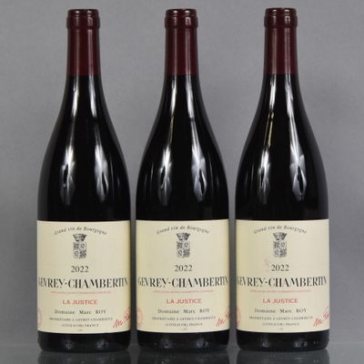 three bottles of wine are lined up on a table