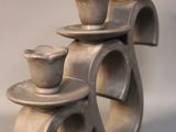 a sculpture of a stack of bowls and saucers on top of each other