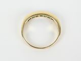 a close up of a gold ring with emeralds on it