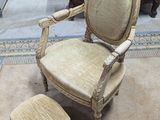 a chair and ottoman in a room with a rug