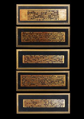a close up of four plaques on a black background