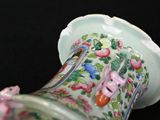 a glass vase with flowers on it sitting on a table
