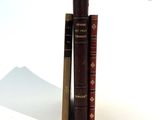 two books sitting next to each other on a white surface