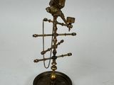 an old brass clock with a bird on top of it