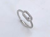 a white gold ring with diamonds on a marble surface
