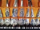 a lot of spoons that are sitting in a case