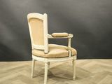 an image of a white chair with a beige upholstered seat