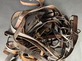 a pile of leather belts on a table