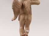 an image of a statue of a child with wings on a pedestal