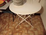 a white table with a stack of plates on top of it