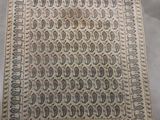 an antique persian rug with a design of paisleys on a beige ground