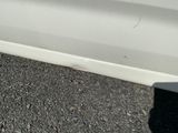 a white car that is parked on the side of the road