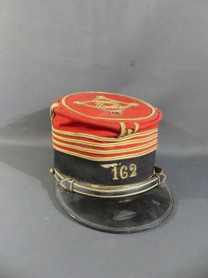 a red and black hat with a gold stripe on it