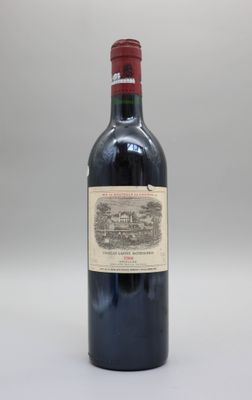 une bouteille de vin rouge posée sur une table blanche