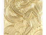 a gold sculpture of a man on a surfboard